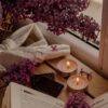 white candle beside white book